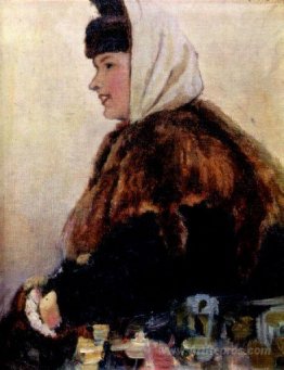 Portrait of young woman in fur coat with muff