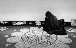 Woman drawing a mandana design, Rajasthan