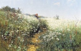 A woman under an umbrella on a flowering meadow