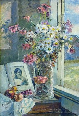 Vase with flowers and book by the window